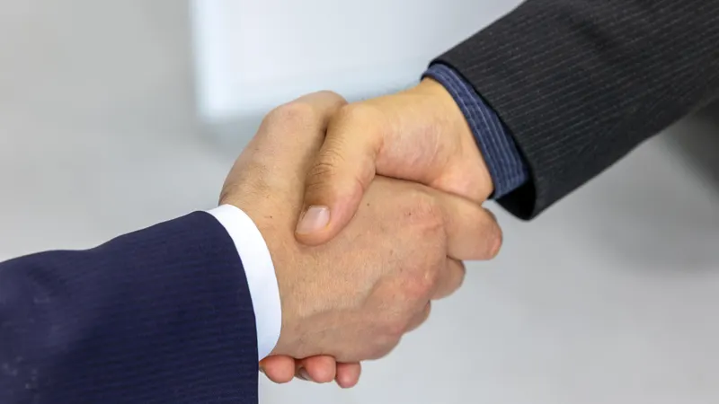 Agency and client shaking hands after agreeing on code and content ownership