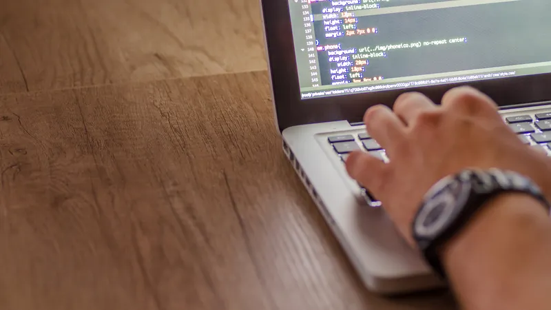 Developer writing code for a website project defined in the contract scope