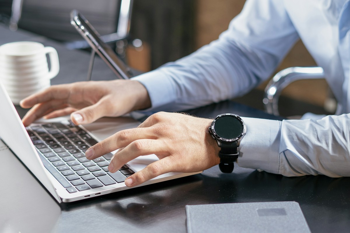 Person typing on a laptop at a desk