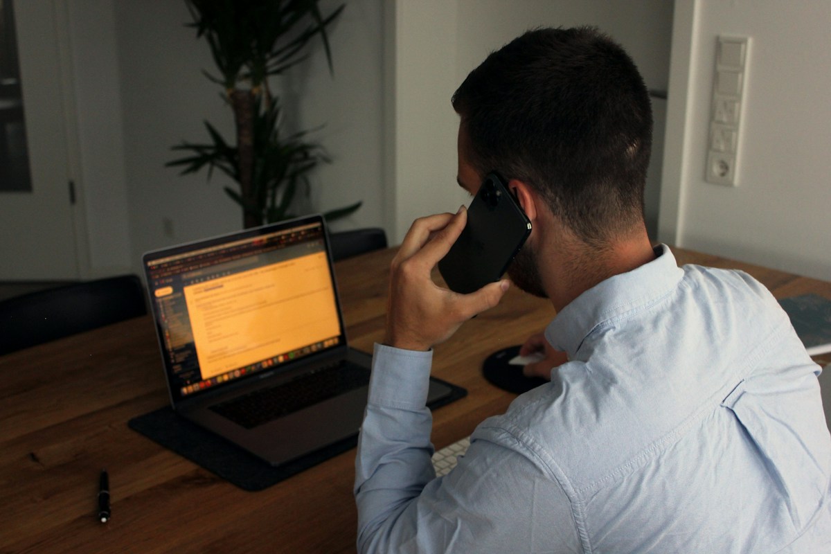 Man in a blue shirt on a phone call with a client